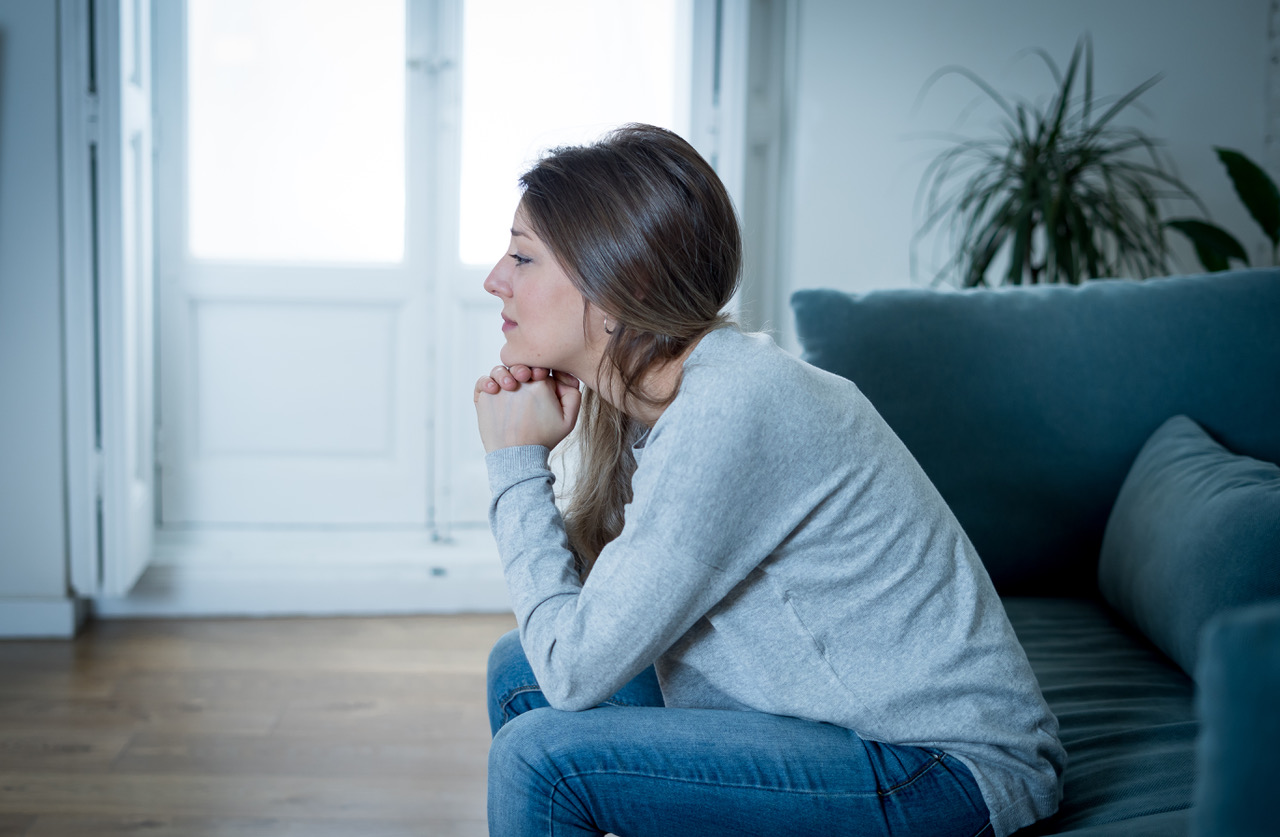 woman sad sitting on sofa