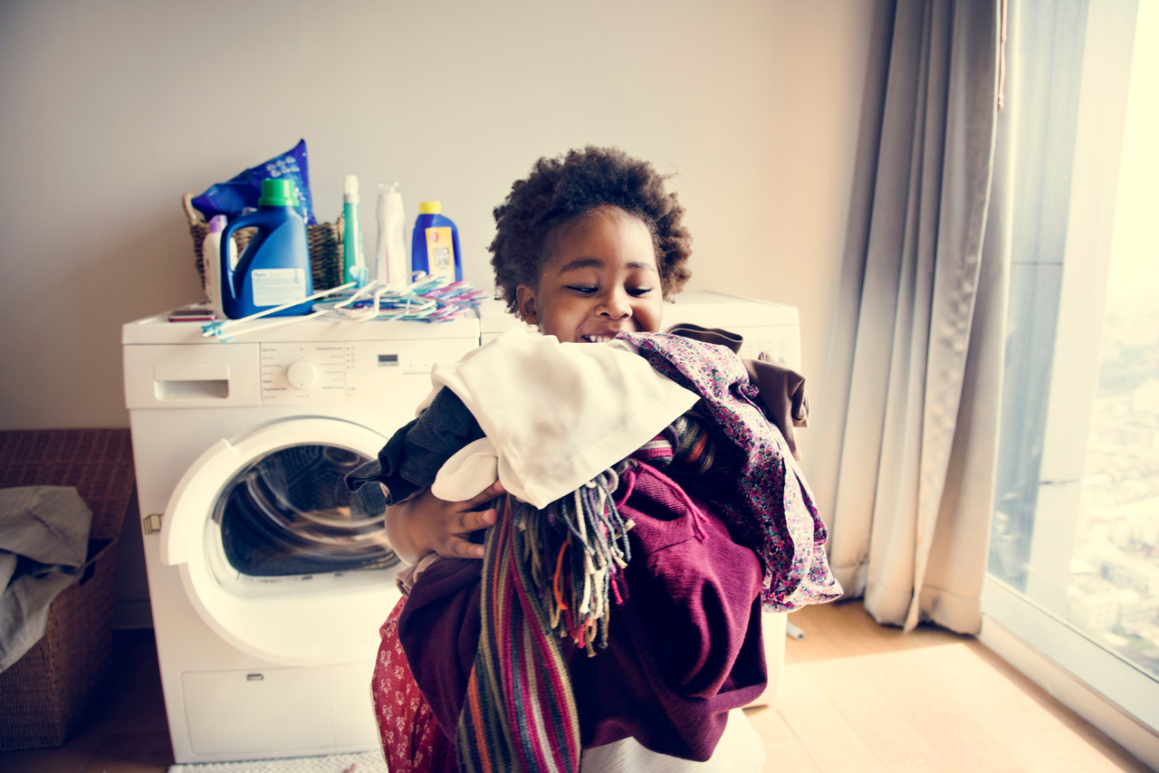 child doing laundry